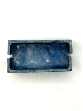 Blue plastic binding brick with opposite slots on short ends and recessed center channel.