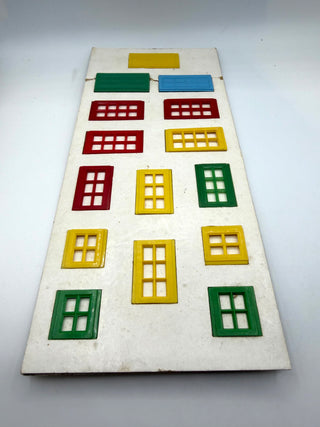 Vintage Kiddicraft building brick card set displaying red, yellow, and green window and door pieces with square grid cutouts 