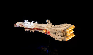 LEGO Tantive IV starship with illuminated engines and interior lighting against black background.