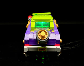 LEGO Joker's Lowrider car with illuminated green windshield, purple body, gold wheels, and green undercarriage lights against