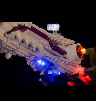 White LEGO spaceship with blue and red LED lights installed throughout the structure and engines.