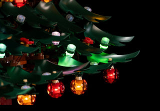 Green LEGO Christmas tree with illuminated red, green, and white LED lights attached to branches.