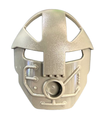 Tan Bionicle Mask Komau with rectangular eye openings, rounded top, mechanical details on sides, and circular port at bottom.