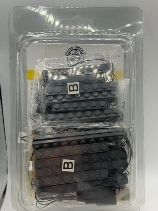 LED light strips with black and dark brown LEGO baseplate connectors in clear blister packaging.