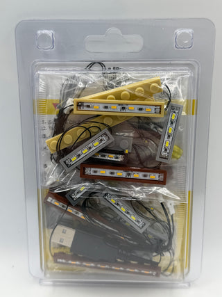 LED lighting strips in yellow, black, and brown with control unit and power cable in blister packaging.