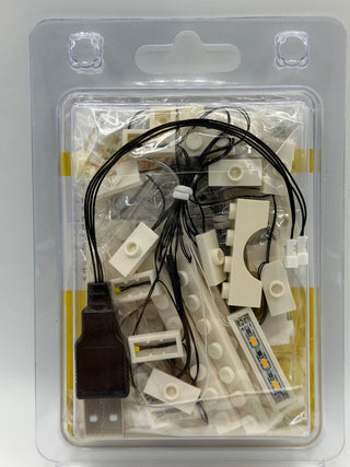 LED lighting kit with white plastic components, black wires, and power adapter in clear blister packaging.