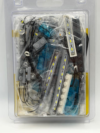 LED lighting kit components including strips, wires, control modules, and connectors in clear plastic packaging.