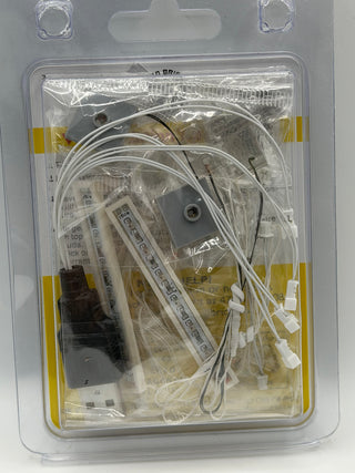 LED lighting kit containing white wire strands, power connector, control module, and mounting brackets in clear blister packa