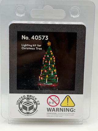 Lighting kit package for LEGO Christmas tree set 40573 with illuminated tree display and warning labels.