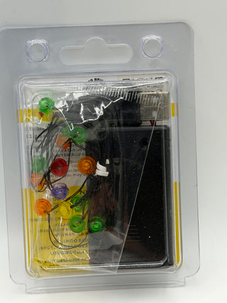 Custom lighting kit containing colored LED bulbs and wiring components in clear blister packaging.