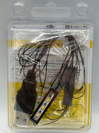 LED lighting kit with power adapter and control module with wired connectors in clear plastic packaging.