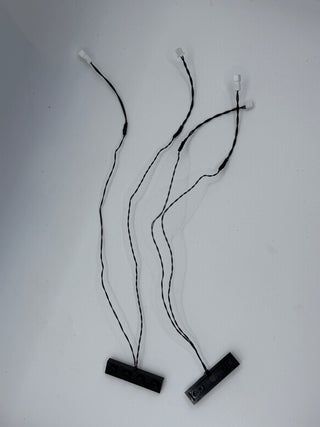 Four black and white power connector cables with vertical plug terminals and base mounting blocks.