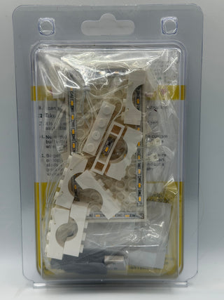 LED lighting kit with white plastic mounts, adhesive strips, and warm-colored light strips in clear clamshell packaging.