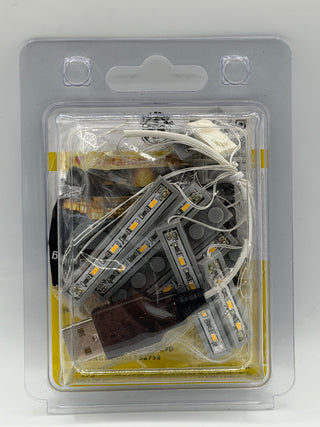 LED light strips with warm-colored diodes, wiring, and USB power adapter in clear clamshell packaging.