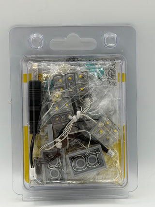 LED lighting kit with multiple small light modules, connectors, wires, and control unit in clear blister packaging.