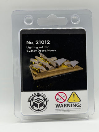 Clear plastic blister package with illuminated Sydney Opera House model on black label and United Brick Co logo with choking 