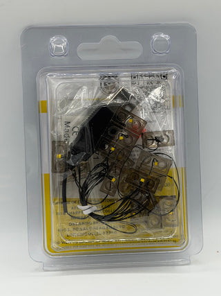 Custom lighting kit containing multiple LED light modules with yellow indicators and black wiring in clear plastic blister pa