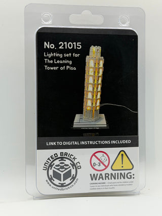 Clear plastic packaging displaying illuminated Leaning Tower of Pisa LEGO model with yellow lights and product details on bla