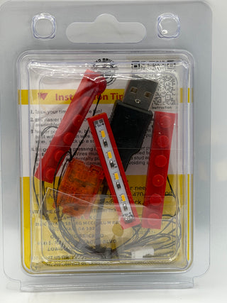 LED lighting kit with red wires, USB connector, LED strips, and instruction manual in clear blister packaging.
