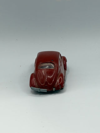 Dark red LEGO Beetle vehicle with rounded body, windshield, and gray bumper, viewed from rear three-quarter angle.