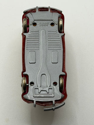 Dark red LEGO VW Beetle model with gray base, metal axles, and embossed details, shown from overhead view.