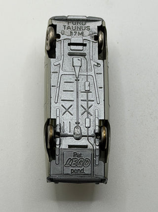 Light gray LEGO Ford Taunus die-cast vehicle shown from top view with black wheels and LEGO branding on base.