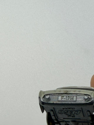 Light gray LEGO Ford Taunus vehicle model shown from front angle with visible grille and license plate detail.