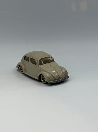 Light gray LEGO VW Beetle miniature model with rounded body, windshield, wheels, and chrome bumper detail.