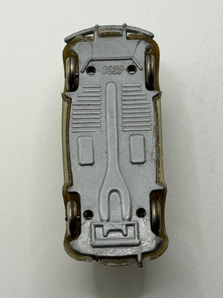 Light gray and olive-toned die-cast VW Beetle toy viewed from above, showing detailed undercarriage and numbered base.