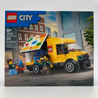 Yellow and black LEGO van with colorful roof awning and two minifigures on urban street backdrop.