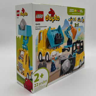 LEGO Duplo construction set with yellow and blue building vehicles, worker minifigures, and black construction equipment piec