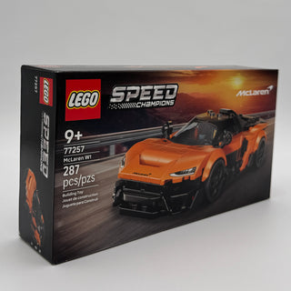 LEGO Speed Champions set box featuring orange McLaren W1 sports car model with black accents and racing track background.