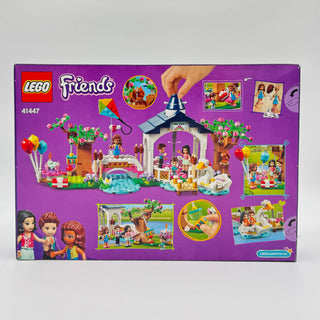 LEGO Friends set 41447 box back showing park pavilion structure, minifigures, and colorful play scenes on purple background.